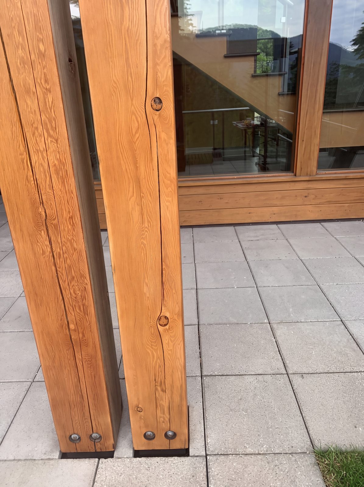 The same timber posts after log home sanding and staining in Whistler BC